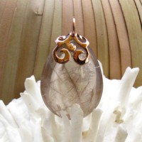 Hand-filigree sterling silver cap pink gold plated setting on a Natural Rutile Quartz. 